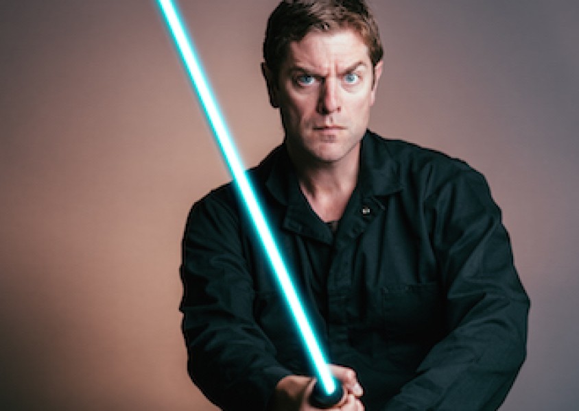 Artist Charles Ross holding blue lightsaber.x
